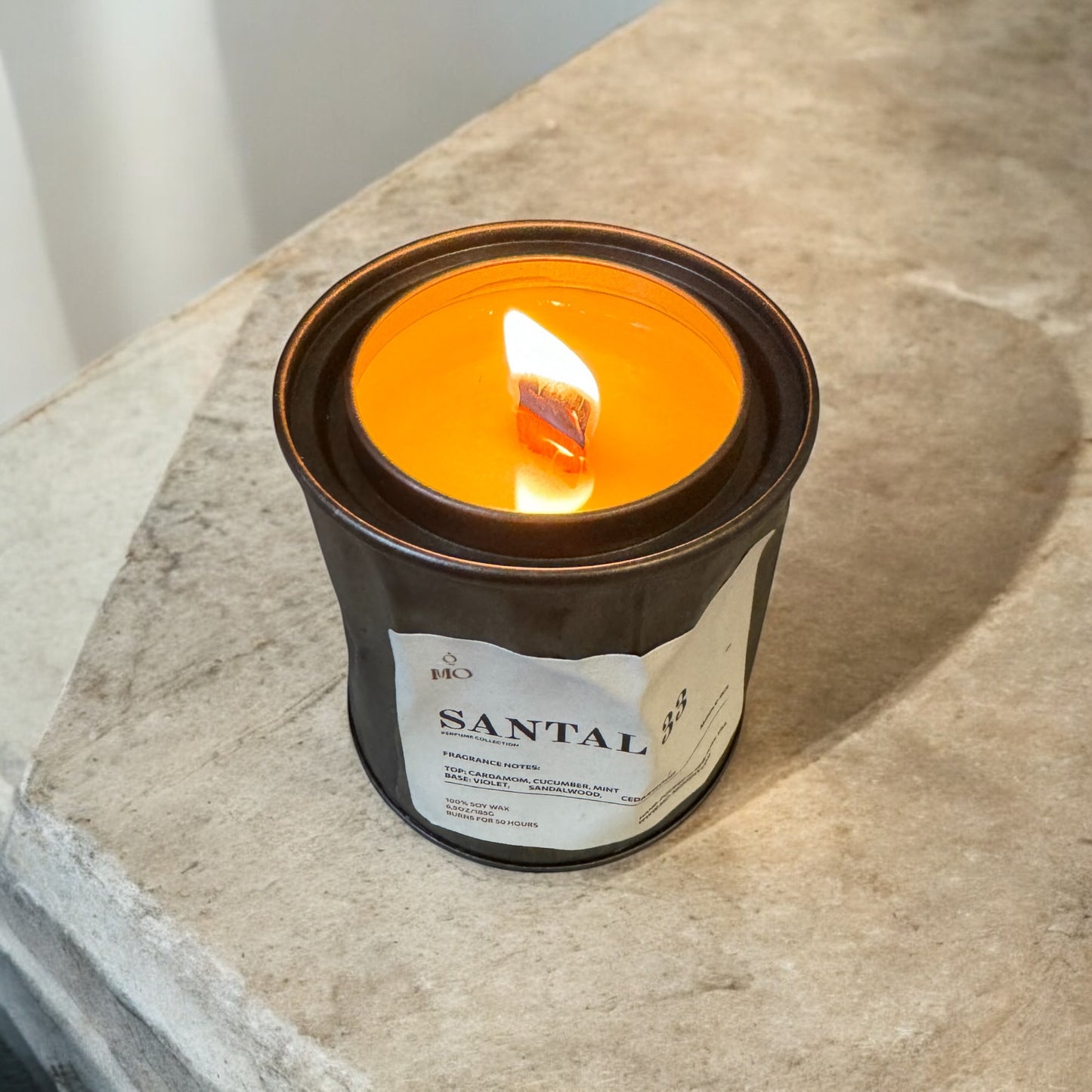 A scented candle made of soy wax in a crumpled metal tin. 6,5 oz